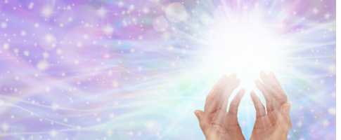 Light coming from healing hands on a purple background