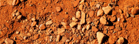 Textured brown soil depicting earth element ray