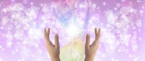 Orbs and sparkles of healing light on a purple background.
