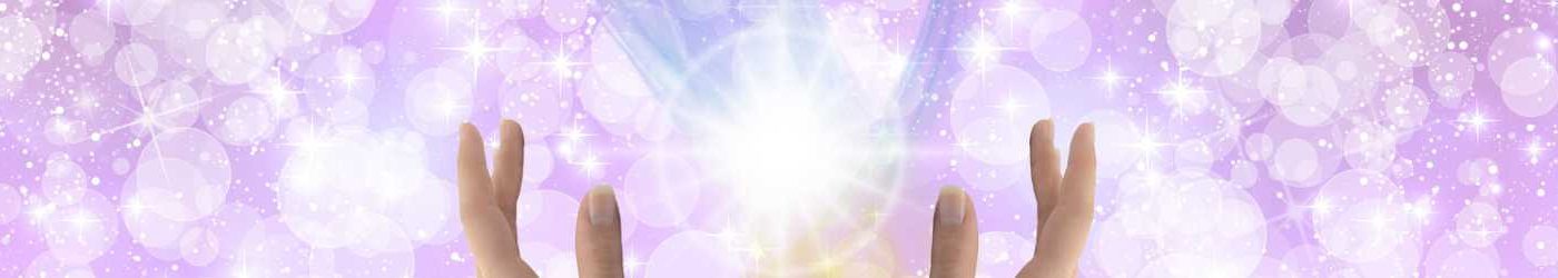 Orbs and sparkles of healing light on a purple background.